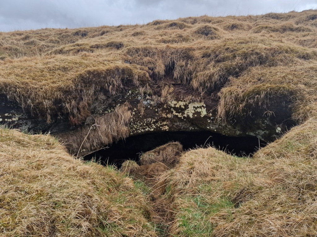 Cave mouth of the cave with bones inside