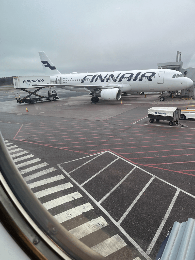 Lentokoneesta otettu kuva missä näkyy Finnairin lentokone lentokentellä